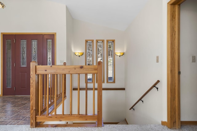 stairway featuring lofted ceiling