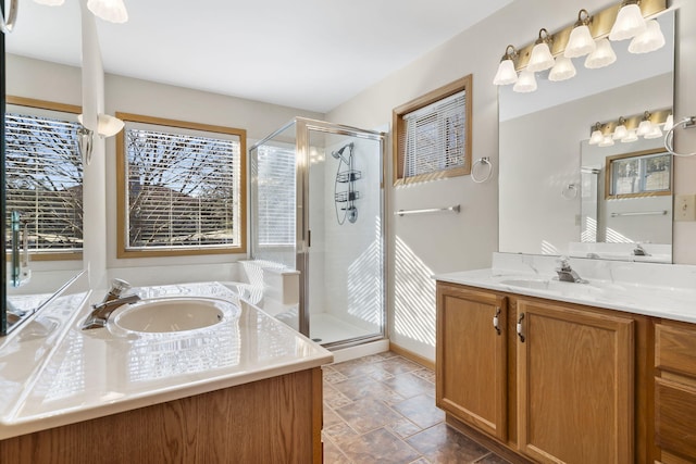 bathroom with walk in shower, a healthy amount of sunlight, and vanity