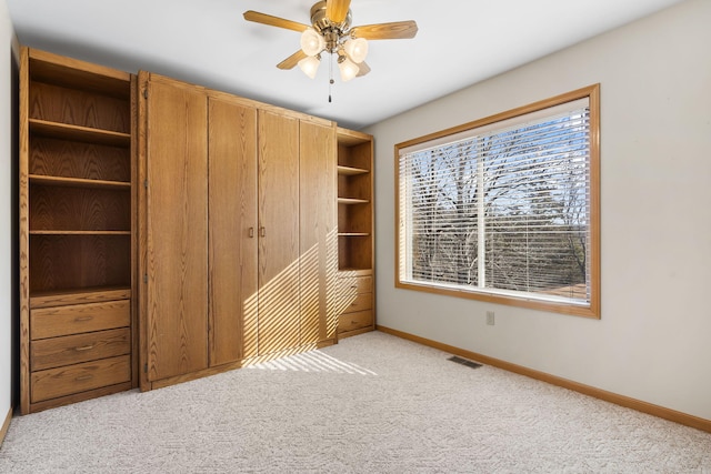 unfurnished bedroom with light carpet and ceiling fan