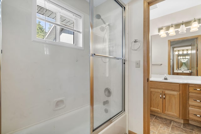 bathroom with enclosed tub / shower combo and vanity