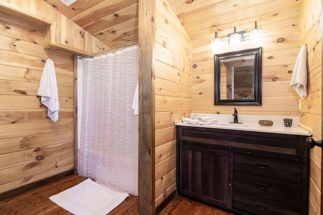 bathroom with wood walls, hardwood / wood-style flooring, vanity, wooden ceiling, and a shower with curtain