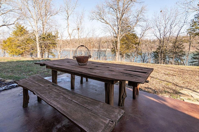 deck featuring a patio area and a water view