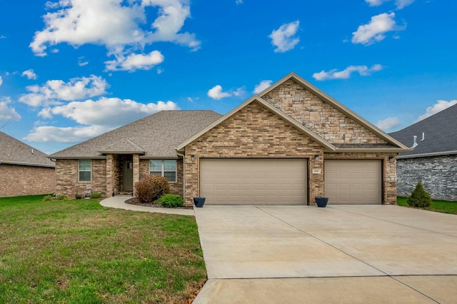 view of front of home featuring a garage and a front yard