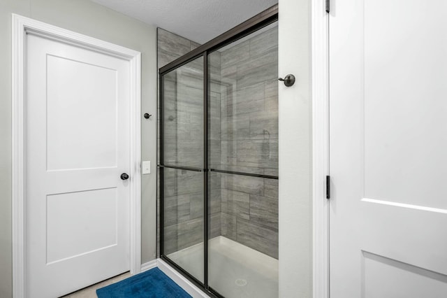 bathroom with a shower with door