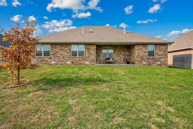 back of house with a yard and a patio area