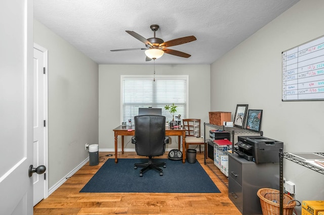 office space with ceiling fan, hardwood / wood-style floors, and a textured ceiling