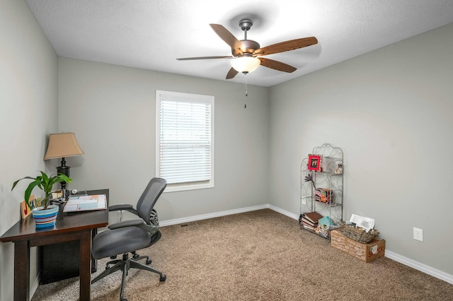 office space with ceiling fan and carpet