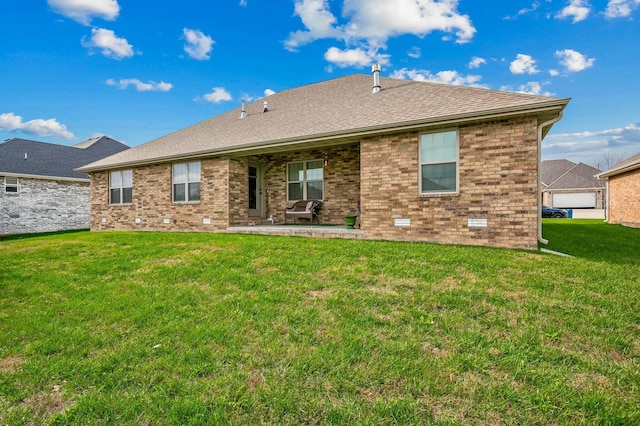 back of property with a patio and a lawn