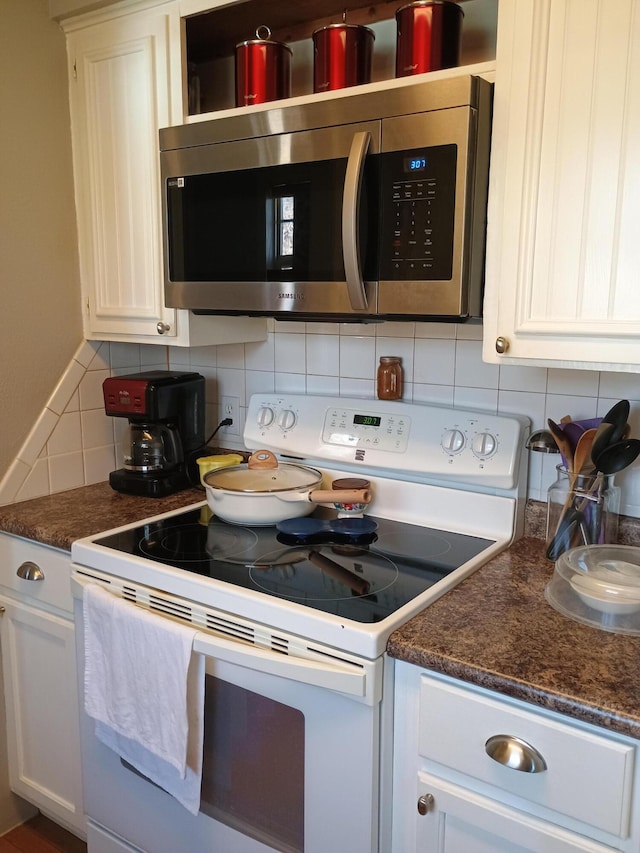 kitchen with white cabinetry, white electric range oven, and decorative backsplash