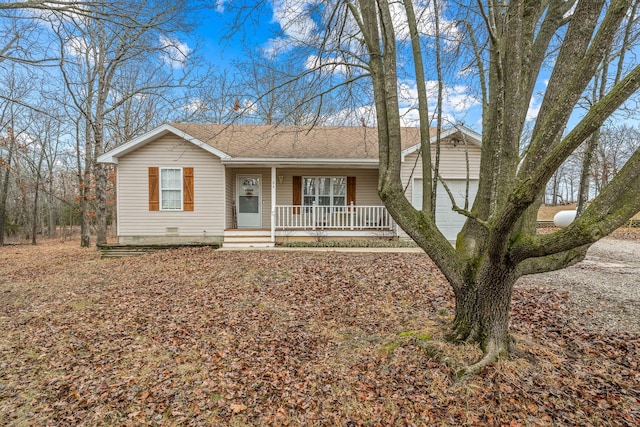 ranch-style home with a porch and a garage