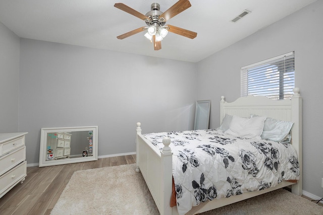 bedroom with ceiling fan and light hardwood / wood-style floors