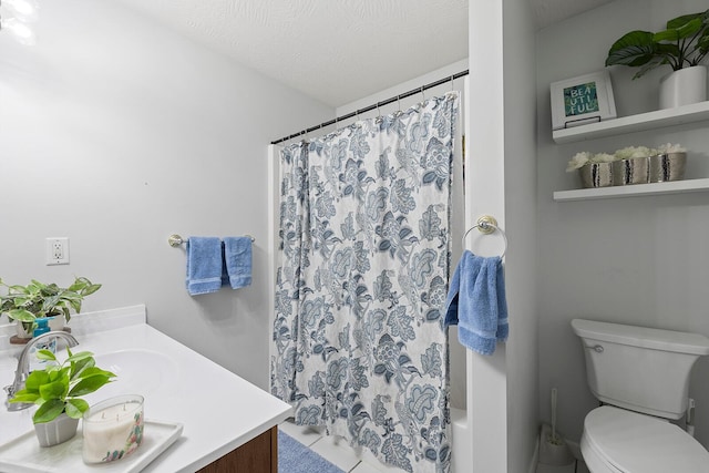 bathroom featuring vanity, a textured ceiling, and toilet