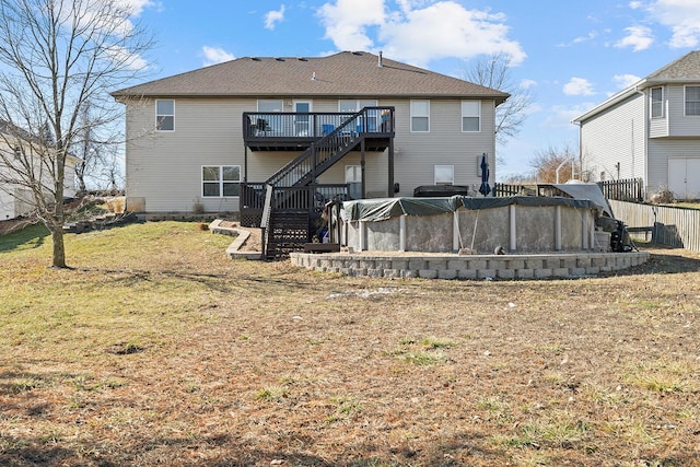 rear view of property with a lawn and a swimming pool side deck