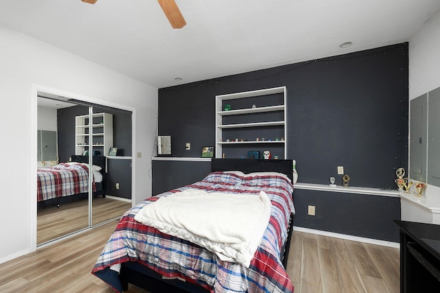 bedroom with hardwood / wood-style floors, a closet, and ceiling fan