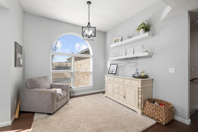 sitting room with light hardwood / wood-style floors and a notable chandelier