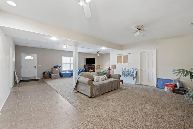 living room featuring light tile patterned flooring and ceiling fan