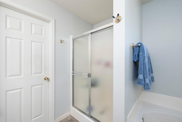 bathroom featuring separate shower and tub