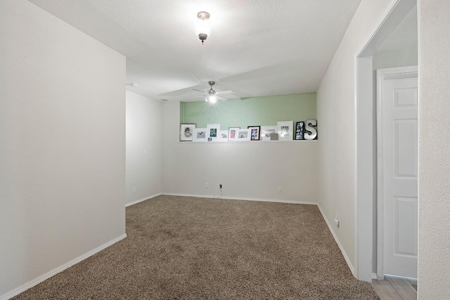 unfurnished room featuring carpet floors, a textured ceiling, and ceiling fan