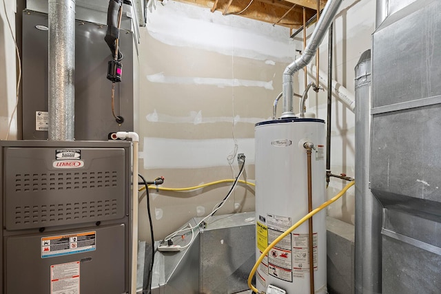 utility room featuring heating unit and gas water heater