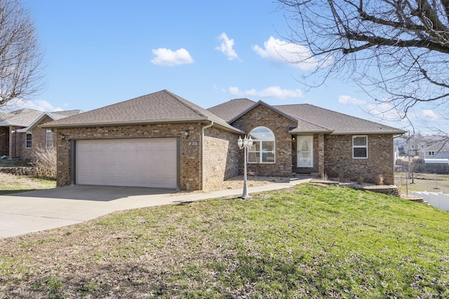 ranch-style home featuring brick siding, concrete driveway, and a front yard