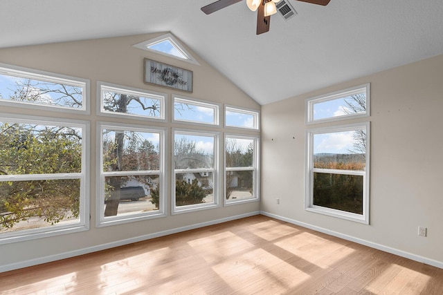 unfurnished sunroom featuring ceiling fan, lofted ceiling, and plenty of natural light