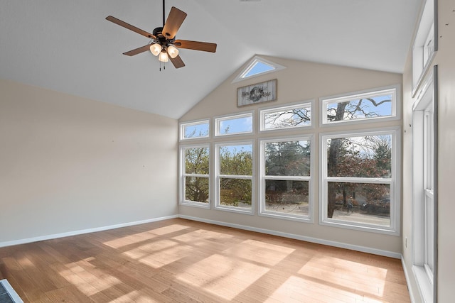 interior space with a wealth of natural light, high vaulted ceiling, and light wood-type flooring