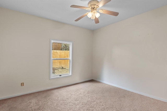 empty room featuring carpet floors and ceiling fan