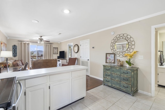 kitchen with ornamental molding, light tile patterned floors, white cabinets, and ceiling fan