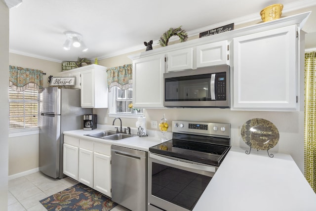 kitchen featuring ornamental molding, stainless steel appliances, sink, and white cabinets