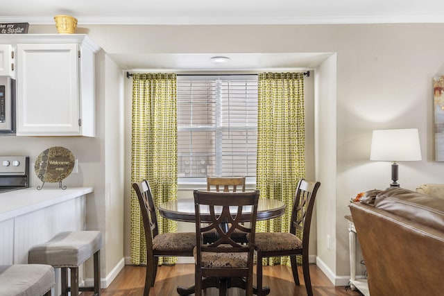 dining room featuring crown molding and wood-type flooring