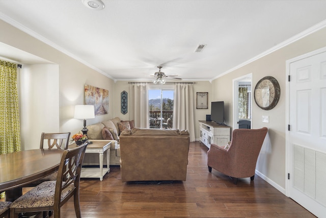 living room featuring ornamental molding, ceiling fan, and dark hardwood / wood-style flooring