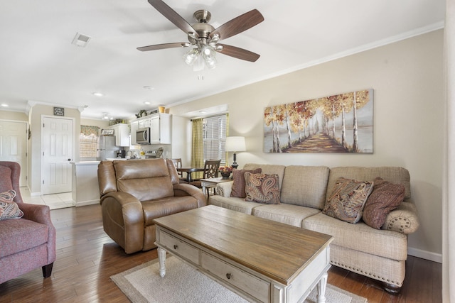 living room with ornamental molding, hardwood / wood-style floors, and ceiling fan