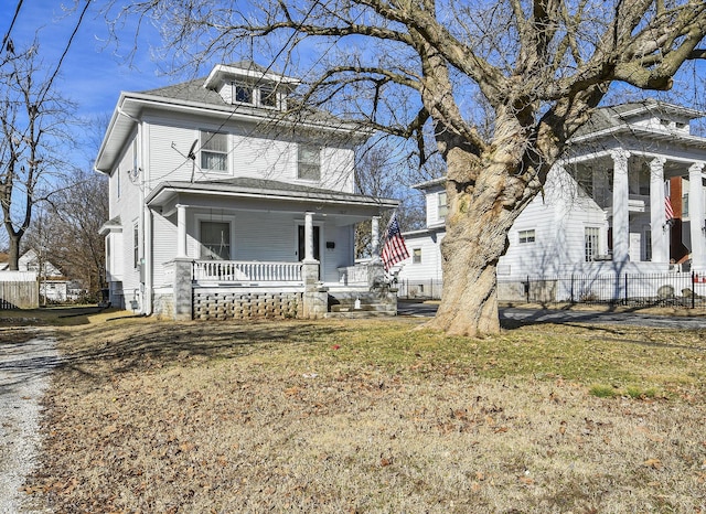 view of front of house featuring a front yard and covered porch