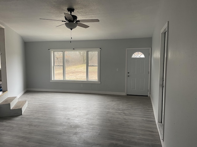 interior space with ceiling fan, wood-type flooring, and a textured ceiling