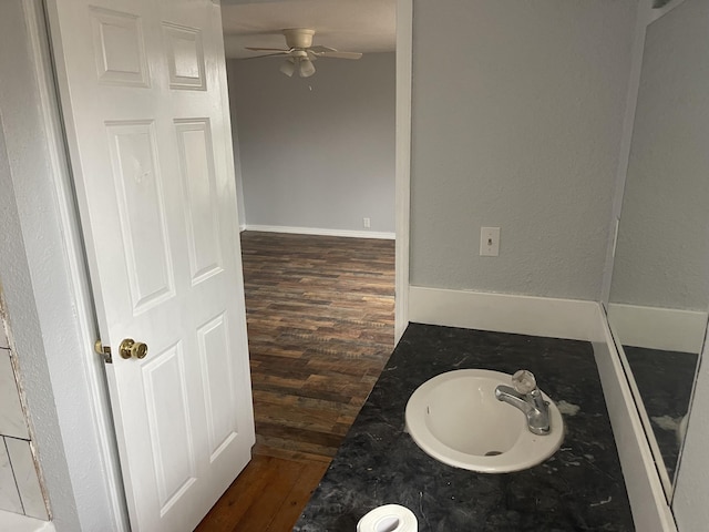 bathroom with hardwood / wood-style flooring, vanity, and ceiling fan