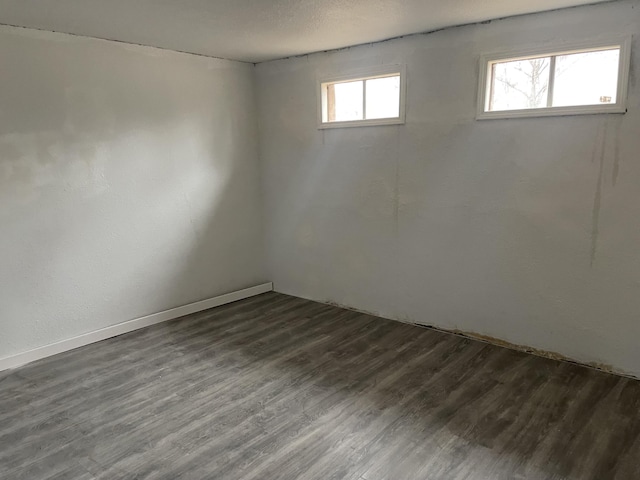 empty room with dark hardwood / wood-style flooring