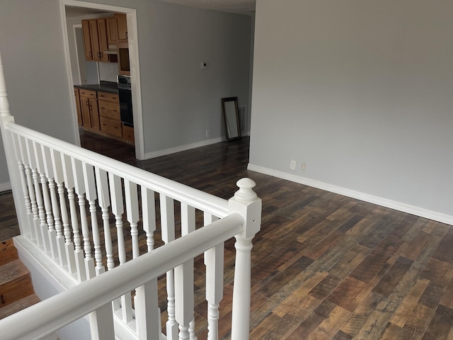 staircase with wood-type flooring