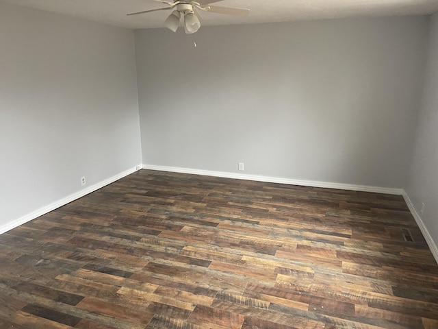 empty room with dark wood-type flooring and ceiling fan