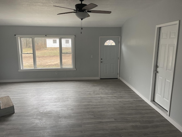 entryway with dark wood-type flooring and ceiling fan