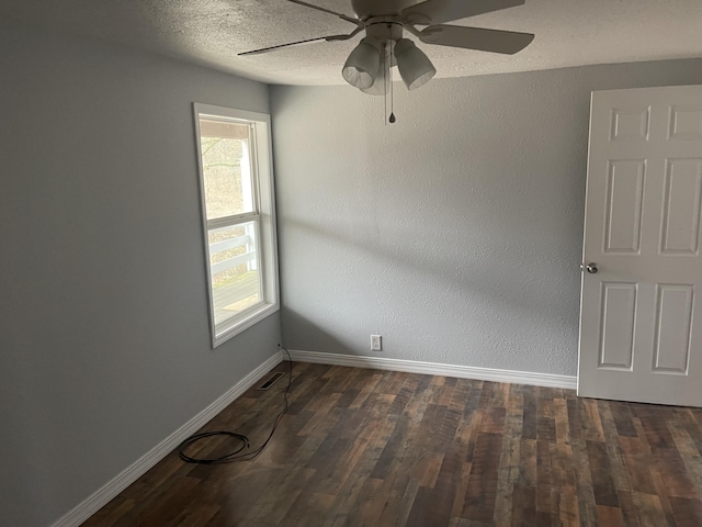 unfurnished room featuring ceiling fan, dark hardwood / wood-style floors, and a textured ceiling