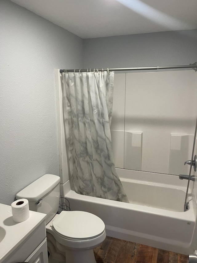 full bathroom featuring vanity, hardwood / wood-style floors, toilet, and shower / bath combo with shower curtain