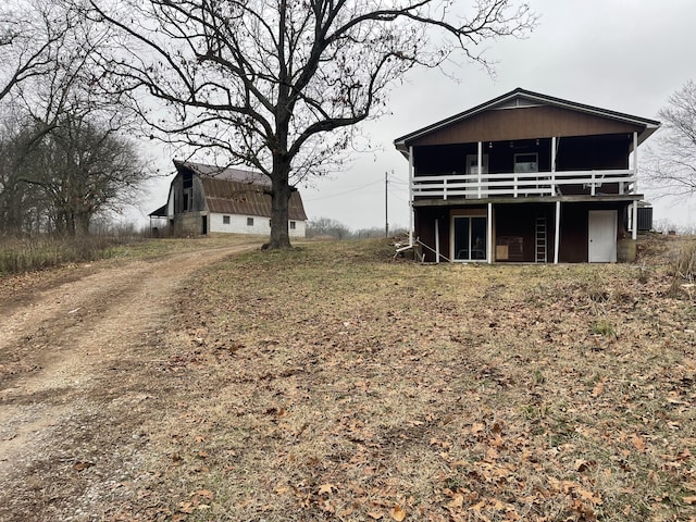 rear view of house featuring a sunroom