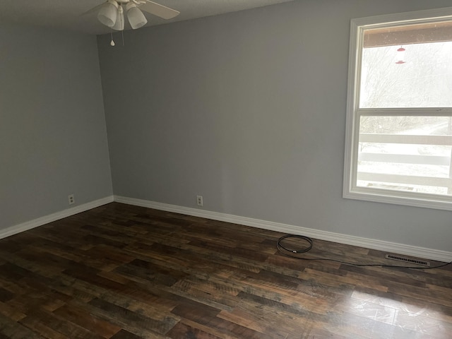 empty room with ceiling fan and dark hardwood / wood-style floors