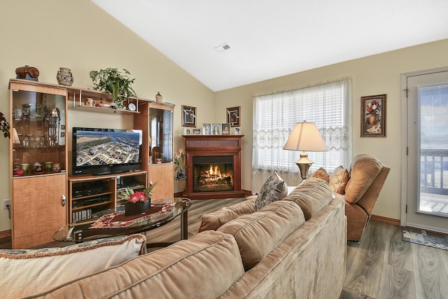 living room featuring vaulted ceiling and light wood-type flooring