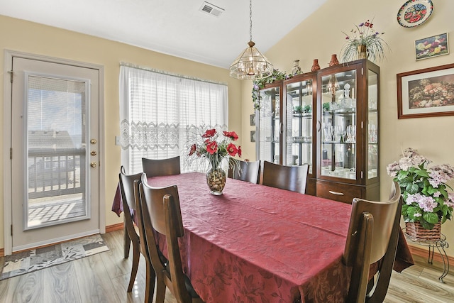 dining space with an inviting chandelier and light wood-type flooring