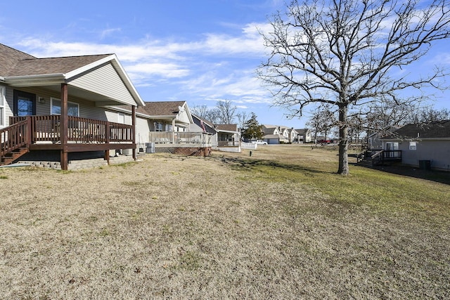 view of yard with a wooden deck and central AC unit