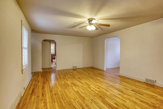 empty room with ceiling fan and light wood-type flooring