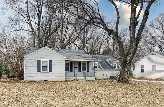 ranch-style home featuring central AC unit and covered porch