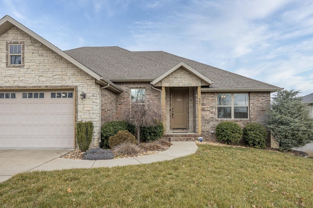 view of front of property with a garage and a front lawn