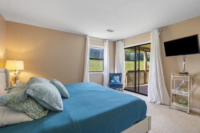 bedroom featuring access to exterior and carpet flooring